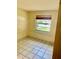 Small bedroom with a window and tiled flooring, offering a simple and functional space at 4394 Prince Hall Blvd, Orlando, FL 32811