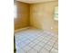 Simple bedroom featuring neutral walls, window providing natural light and tiled floors at 4394 Prince Hall Blvd, Orlando, FL 32811