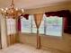 Dining area with tile floors, ample sunlight and vintage chandelier at 4394 Prince Hall Blvd, Orlando, FL 32811
