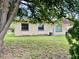 Classic home featuring large windows and mature trees at 4394 Prince Hall Blvd, Orlando, FL 32811