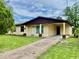 Charming one-story home features a welcoming front porch and a well-maintained lawn at 4394 Prince Hall Blvd, Orlando, FL 32811