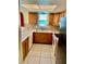 The kitchen features wooden cabinets and tile floors, with a window providing natural light at 4394 Prince Hall Blvd, Orlando, FL 32811