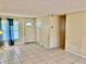 A view of a living room area with tile floors and a door at 4394 Prince Hall Blvd, Orlando, FL 32811