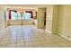 Bright living room features tile flooring, large windows, and vintage chandelier at 4394 Prince Hall Blvd, Orlando, FL 32811