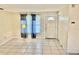 A view of a living room area with tile floors and a door at 4394 Prince Hall Blvd, Orlando, FL 32811