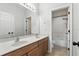 Bathroom with a double vanity, a large mirror, and a separate toilet and shower room at 4509 Belkin Ct, Orlando, FL 32814
