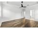 Spacious bedroom with tray ceilings, ceiling fan, wood floors, and natural light at 4509 Belkin Ct, Orlando, FL 32814