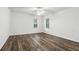 Spacious bedroom featuring wood floors, a ceiling fan, and large windows at 4509 Belkin Ct, Orlando, FL 32814