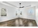 Bright, spacious bedroom with tray ceiling, ceiling fan, and large windows at 4509 Belkin Ct, Orlando, FL 32814