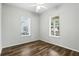 Cozy bedroom featuring wood floors and large windows allowing for natural light, creating a warm and inviting space at 4509 Belkin Ct, Orlando, FL 32814