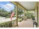 Spacious front porch with beautiful brick flooring, ample seating area and views of the well-manicured front yard at 4509 Belkin Ct, Orlando, FL 32814