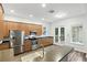 Modern kitchen boasts stainless appliances, ample counter space, and sleek wood cabinetry at 4509 Belkin Ct, Orlando, FL 32814
