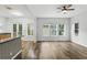 Bright, open living room with wood floors, large windows and access to outdoor space at 4509 Belkin Ct, Orlando, FL 32814