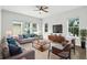 Comfortable living room features neutral tones, ample seating, large windows, and a ceiling fan at 4509 Belkin Ct, Orlando, FL 32814