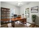 Bright home office featuring a large wooden desk, a bookshelf, and large windows offering plenty of natural light at 4509 Belkin Ct, Orlando, FL 32814