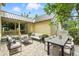 Backyard patio featuring an outdoor table, outdoor seating, and landscaping at 4509 Belkin Ct, Orlando, FL 32814