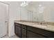Bathroom vanity features a granite countertop, double sinks and dark wood cabinets at 452 Diamond Dove Cv, Winter Springs, FL 32708
