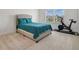 Bedroom with carpet, a gray upholstered bed, and a Peloton bike at 452 Diamond Dove Cv, Winter Springs, FL 32708