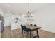 Open-concept kitchen and dining area with stainless steel appliances, modern lighting, and stylish dining table at 452 Diamond Dove Cv, Winter Springs, FL 32708