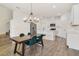 Open-concept kitchen and dining area with stainless steel appliances, modern lighting, and stylish dining table at 452 Diamond Dove Cv, Winter Springs, FL 32708