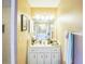 Bright bathroom with a vanity sink and an oversized mirror that reflects another vanity at 4633 Sw 103Rd Pl, Ocala, FL 34476