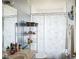 Cozy bathroom featuring a vanity, decorative shelves, and a charming floral shower curtain at 4633 Sw 103Rd Pl, Ocala, FL 34476
