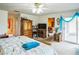 Bright bedroom with wood furniture, white walls, and a sliding glass door leading to the outside at 4633 Sw 103Rd Pl, Ocala, FL 34476