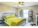 A cozy bedroom featuring a metal frame bed, a window with blinds, and gray walls at 4633 Sw 103Rd Pl, Ocala, FL 34476