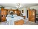A spacious bedroom featuring light wood built-ins, white walls, and a ceiling fan with lights at 4633 Sw 103Rd Pl, Ocala, FL 34476