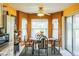 Cozy dining area with a ceiling fan, an oval table, and natural light from a sliding glass door and two windows at 4633 Sw 103Rd Pl, Ocala, FL 34476