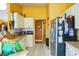 Functional kitchen featuring white cabinets, a refrigerator, and a convenient layout at 4633 Sw 103Rd Pl, Ocala, FL 34476
