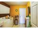 Practical laundry room with washer, dryer, storage cabinets, and a neutral color scheme at 4633 Sw 103Rd Pl, Ocala, FL 34476