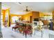 Open-concept living room showcasing a fireplace and kitchen for gathering and relaxation at 4633 Sw 103Rd Pl, Ocala, FL 34476