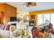 Open-concept living room showcasing couches, fireplace, piano, and sliding glass doors to outside at 4633 Sw 103Rd Pl, Ocala, FL 34476