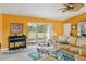 Relaxing living room with large leather couch, piano, sliding glass doors, and decorative table at 4633 Sw 103Rd Pl, Ocala, FL 34476