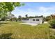 Backyard featuring a well-maintained lawn, concrete patio, and a neutral-colored home exterior at 4714 Abaca St, Orlando, FL 32808
