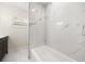 Elegant bathroom featuring white marble tile, a modern tub, and natural light at 4714 Abaca St, Orlando, FL 32808