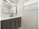 Stylish bathroom with black vanity, modern lighting, and sleek design at 4714 Abaca St, Orlando, FL 32808