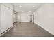 Spacious bedroom with gray wood floors, recessed lighting, and white double closet doors at 4714 Abaca St, Orlando, FL 32808