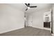 Clean, spacious bedroom with a ceiling fan and an ensuite bathroom visible in the background at 4714 Abaca St, Orlando, FL 32808