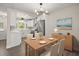 Modern dining area with stainless steel appliances, modern lighting, and white cabinets at 4714 Abaca St, Orlando, FL 32808