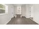 Bright hallway with gray wood floors, white trim, and multiple doorways for easy access at 4714 Abaca St, Orlando, FL 32808