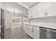 Open kitchen, offering white cabinets with modern hardware, with stainless appliances and hardwood flooring at 4714 Abaca St, Orlando, FL 32808