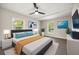 Modern main bedroom with art, ceiling fan, and streaming natural light at 4714 Abaca St, Orlando, FL 32808