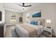 Comfortable main bedroom featuring soft blue accents, natural light, and stylish decor at 4714 Abaca St, Orlando, FL 32808