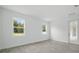 Bright bedroom with tile flooring and two windows overlooking a green space view at 5204 Obsidian Gate Dr, Mount Dora, FL 32757