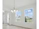 Bright dining room filled with natural light and elegant light fixture at 5204 Obsidian Gate Dr, Mount Dora, FL 32757
