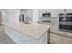 Bright kitchen featuring large island with granite countertops at 5204 Obsidian Gate Dr, Mount Dora, FL 32757