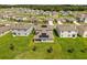 Aerial view of a community featuring green homes, solar panels, and manicured lawns, nestled in a serene neighborhood at 5226 Mahogany Dr, Mount Dora, FL 32757