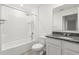 Bright bathroom featuring a shower and tub, a toilet, and a granite vanity with a sink and a large mirror at 5226 Mahogany Dr, Mount Dora, FL 32757